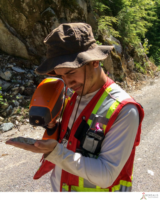 A Borealis Geothermal team member with a worker's vest using a  SWIR Spectral Analysis apparatus